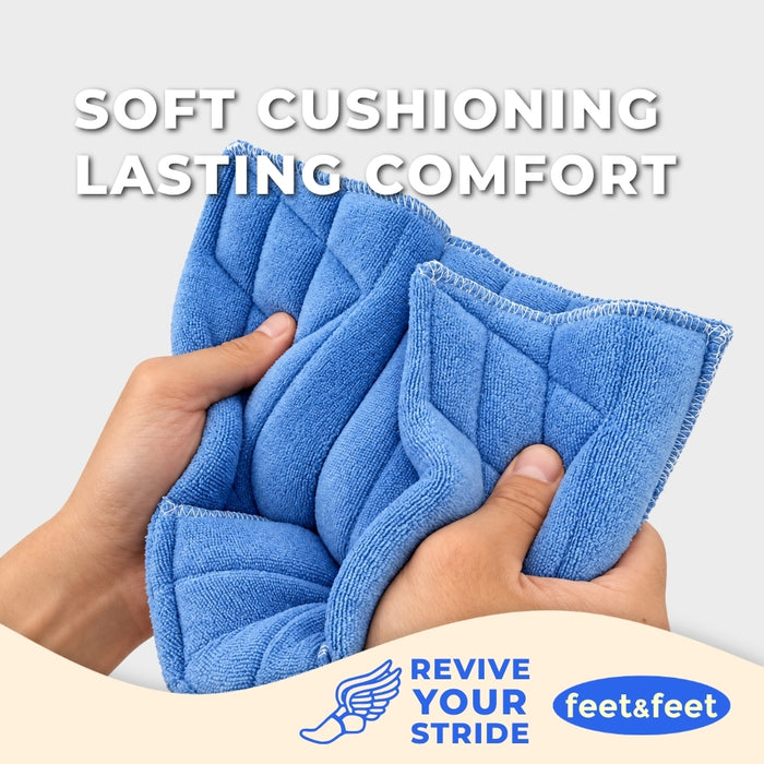 Blue quilted cushioned footbed inserts being held by two hands to demonstrate their soft, pliable texture. 