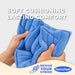 Blue quilted cushioned footbed inserts being held by two hands to demonstrate their soft, pliable texture. 